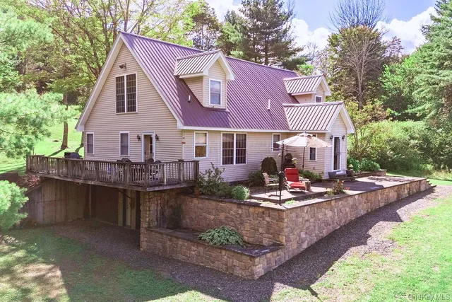 a front view of a house with a yard table and chairs