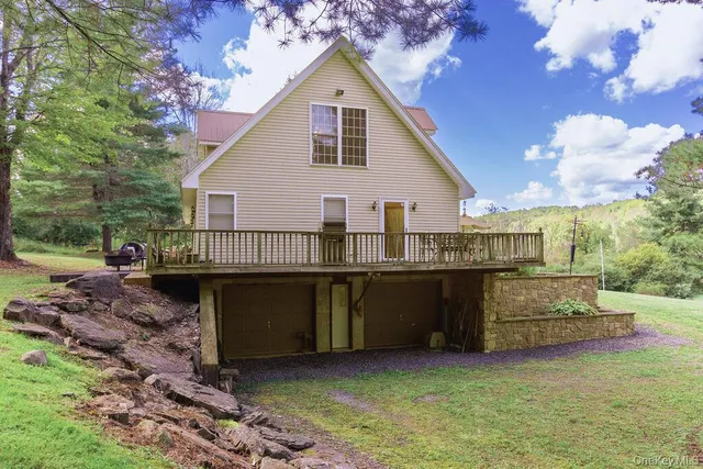 a view of a house with roof deck and sitting area