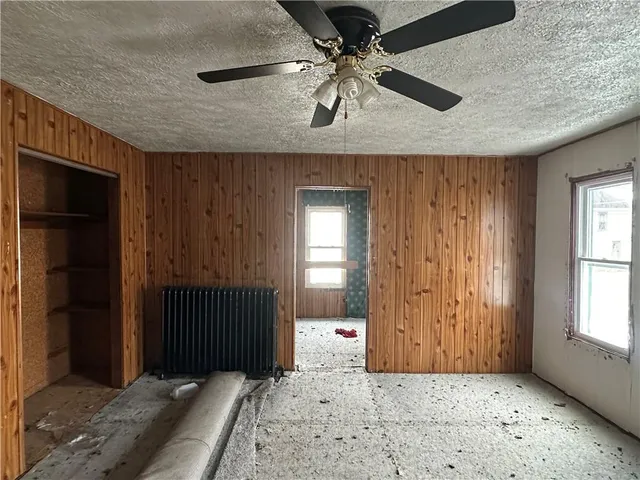 an empty room with windows and closet