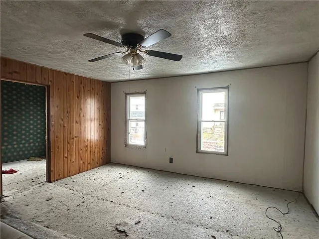 a view of a livingroom with a ceiling fan and window