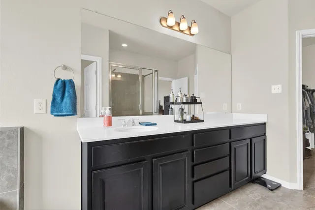 a large bathroom with a double vanity sink and a mirror