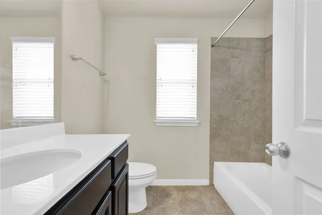 a living room with furniture and a ceiling fan