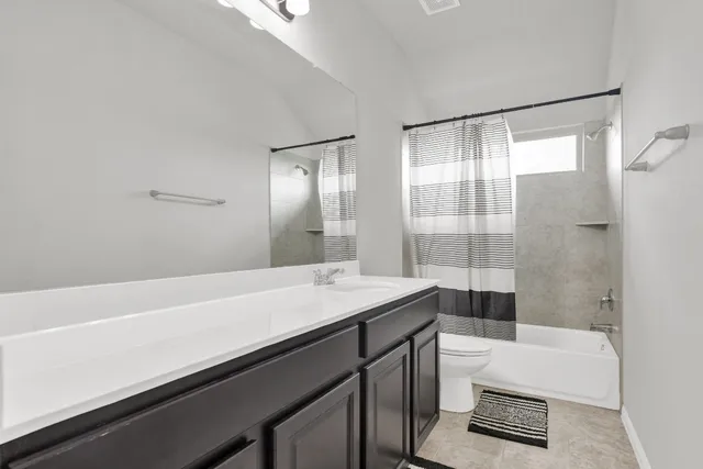 a bedroom with a bed a couch and window