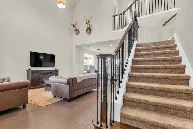 a living room with furniture and stairs