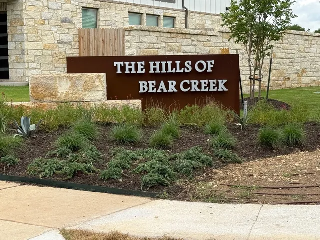 a patio with a table and chairs under an umbrella