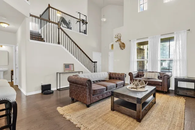 a living room with furniture ceiling fan and a window
