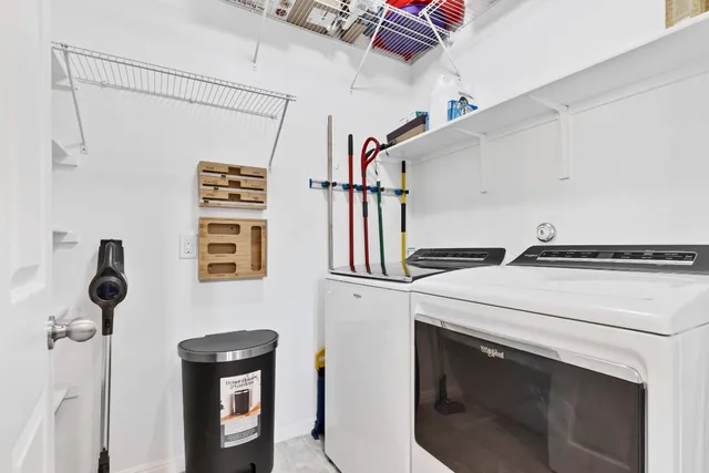 a kitchen with kitchen island granite countertop a stove and a refrigerator