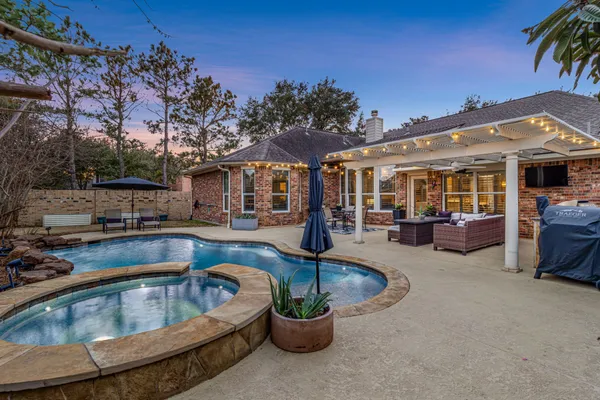 a view of a house with swimming pool and furniture