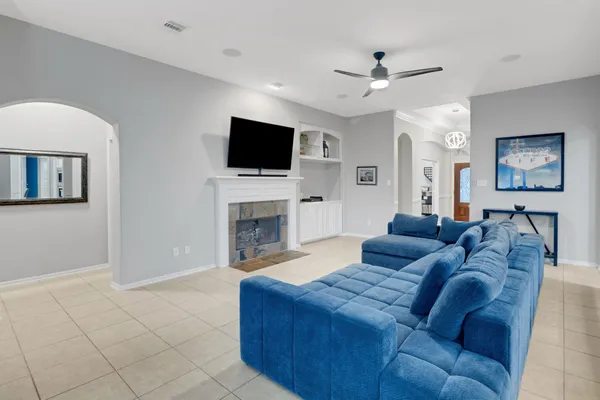 a living room with furniture a flat screen tv and a fireplace
