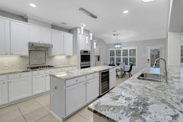a kitchen with sink stove and cabinets