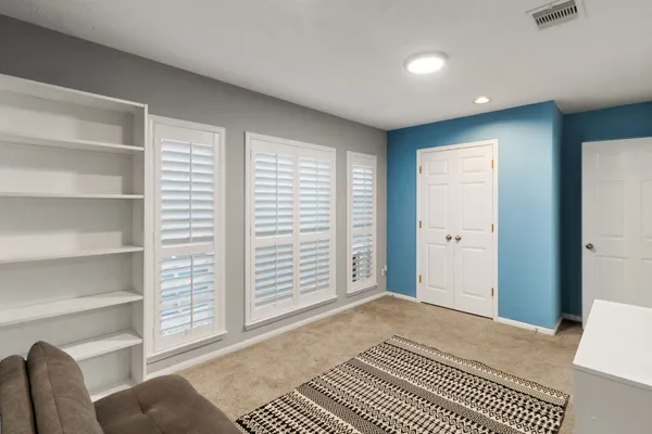 a bedroom with a large bed and a window