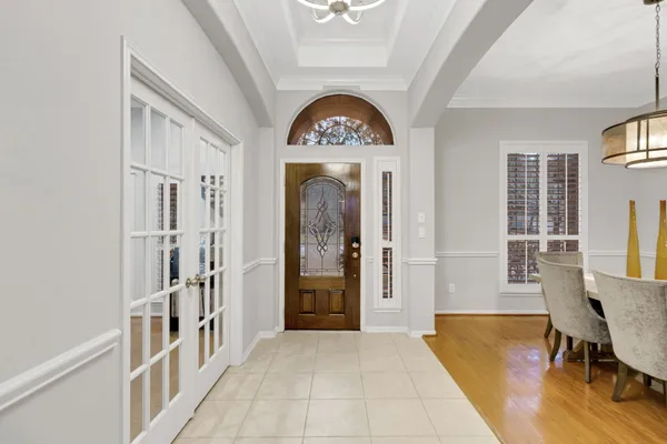 a room with a table chairs and entryway