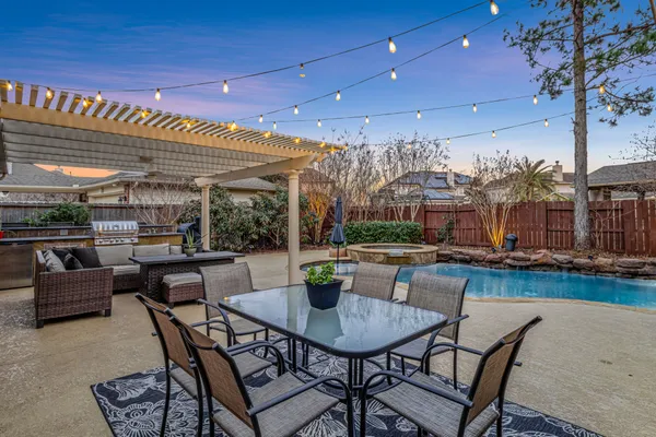 a view of a patio with table and chairs