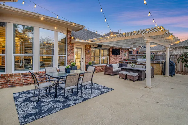 a swimming pool with outdoor seating and yard
