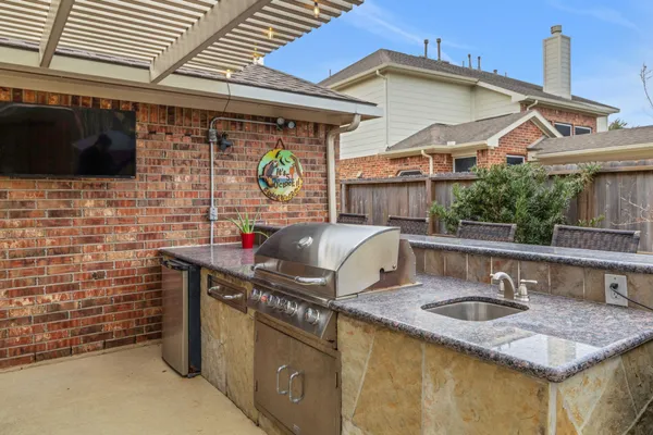 an aerial view of residential house with outdoor space and swimming pool