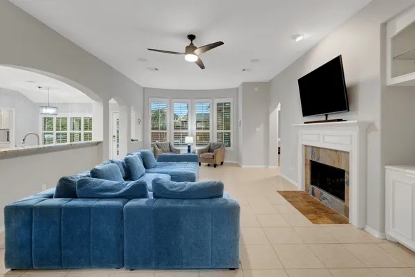 a living room with furniture a flat screen tv and a fireplace