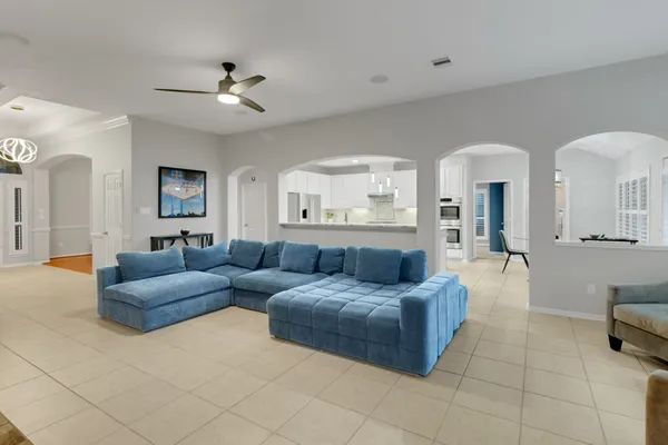 a living room with furniture and a chandelier