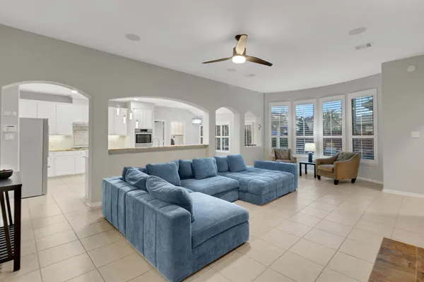 a living room with furniture and a chandelier