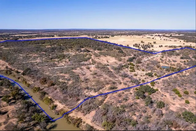 a view of a large body of water with a building in the background