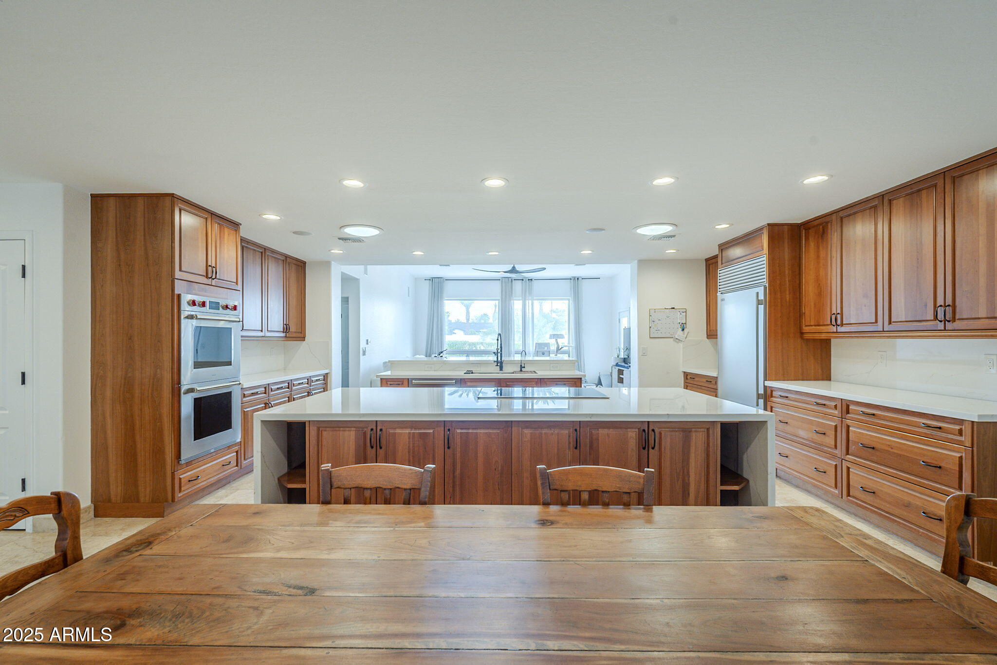 6302 East Cochise Road Paradise Valley, AZ 85253 - Photo 10 of 44 a large kitchen with kitchen island a sink table and chairs