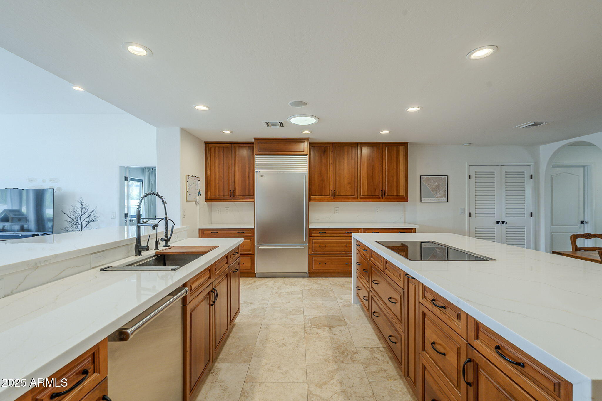 6302 East Cochise Road Paradise Valley, AZ 85253 - Photo 14 of 44 a kitchen with stainless steel appliances granite countertop a sink and a refrigerator