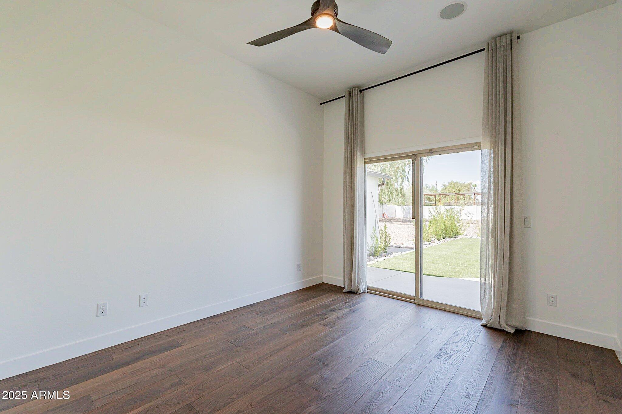 6302 East Cochise Road Paradise Valley, AZ 85253 - Photo 23 of 44 a view of an empty room with wooden floor and a window