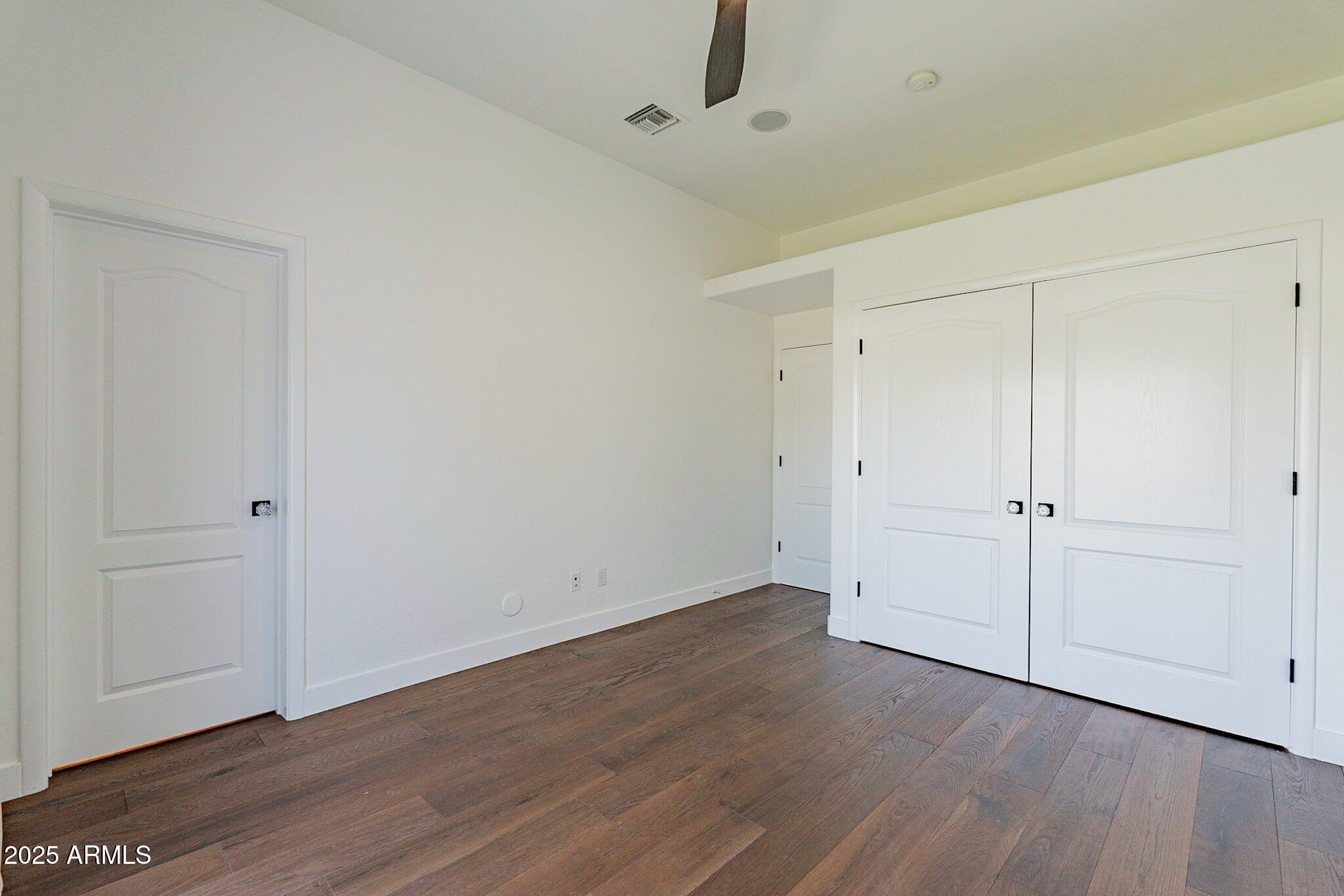 6302 East Cochise Road Paradise Valley, AZ 85253 - Photo 24 of 44 a view of an empty room with wooden floor
