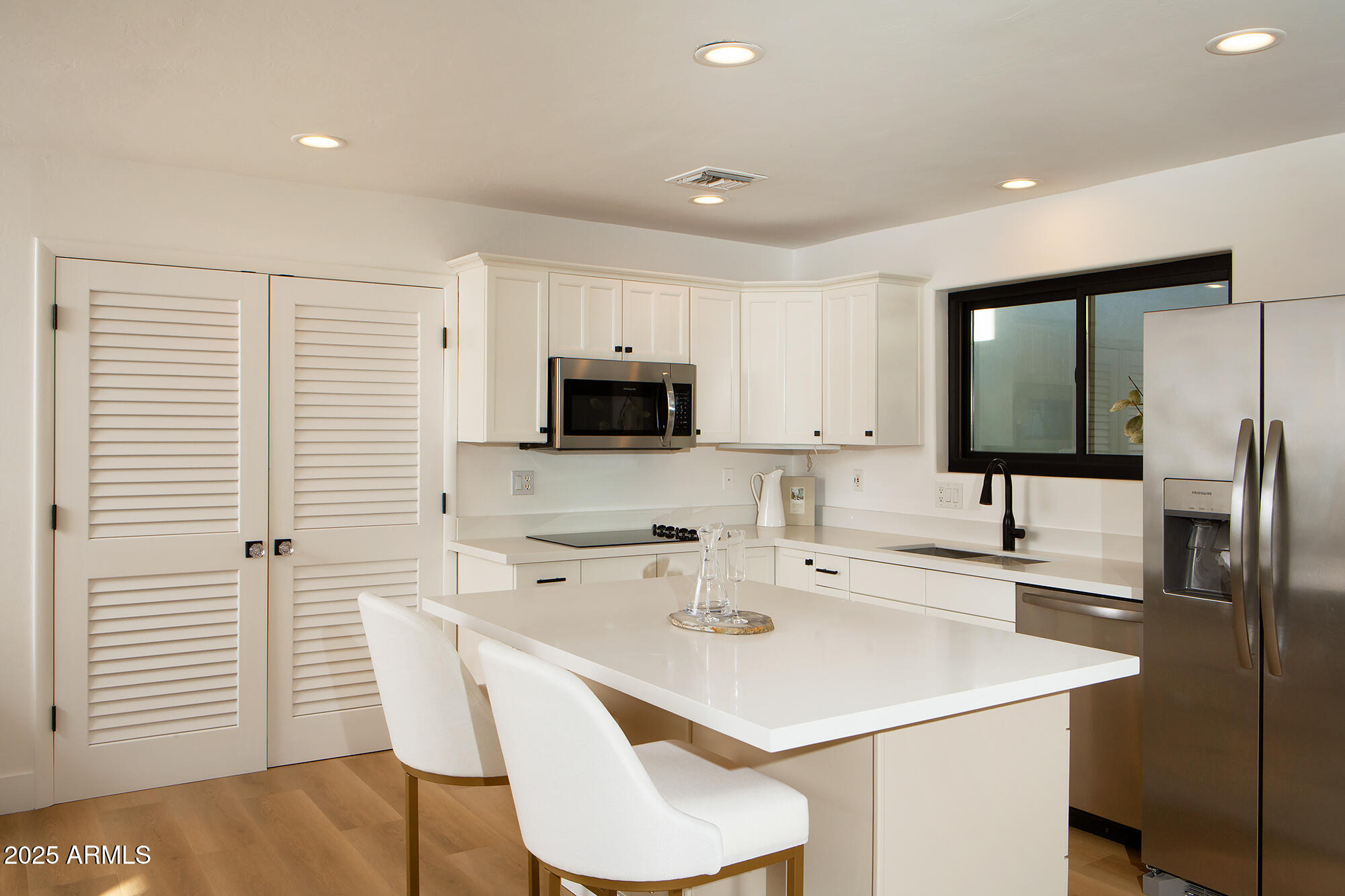 6302 East Cochise Road Paradise Valley, AZ 85253 - Photo 26 of 44 a kitchen with a sink a microwave and cabinets