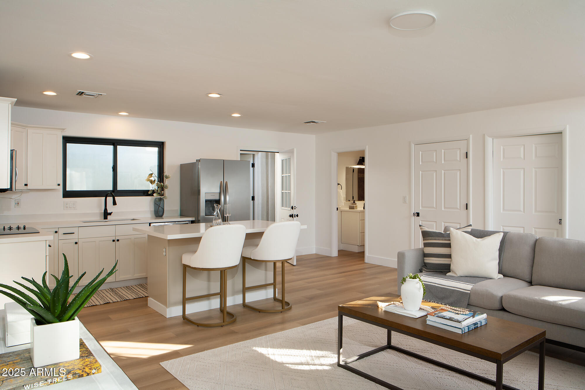 6302 East Cochise Road Paradise Valley, AZ 85253 - Photo 27 of 44 a living room with furniture a large window and a dining table with wooden floor