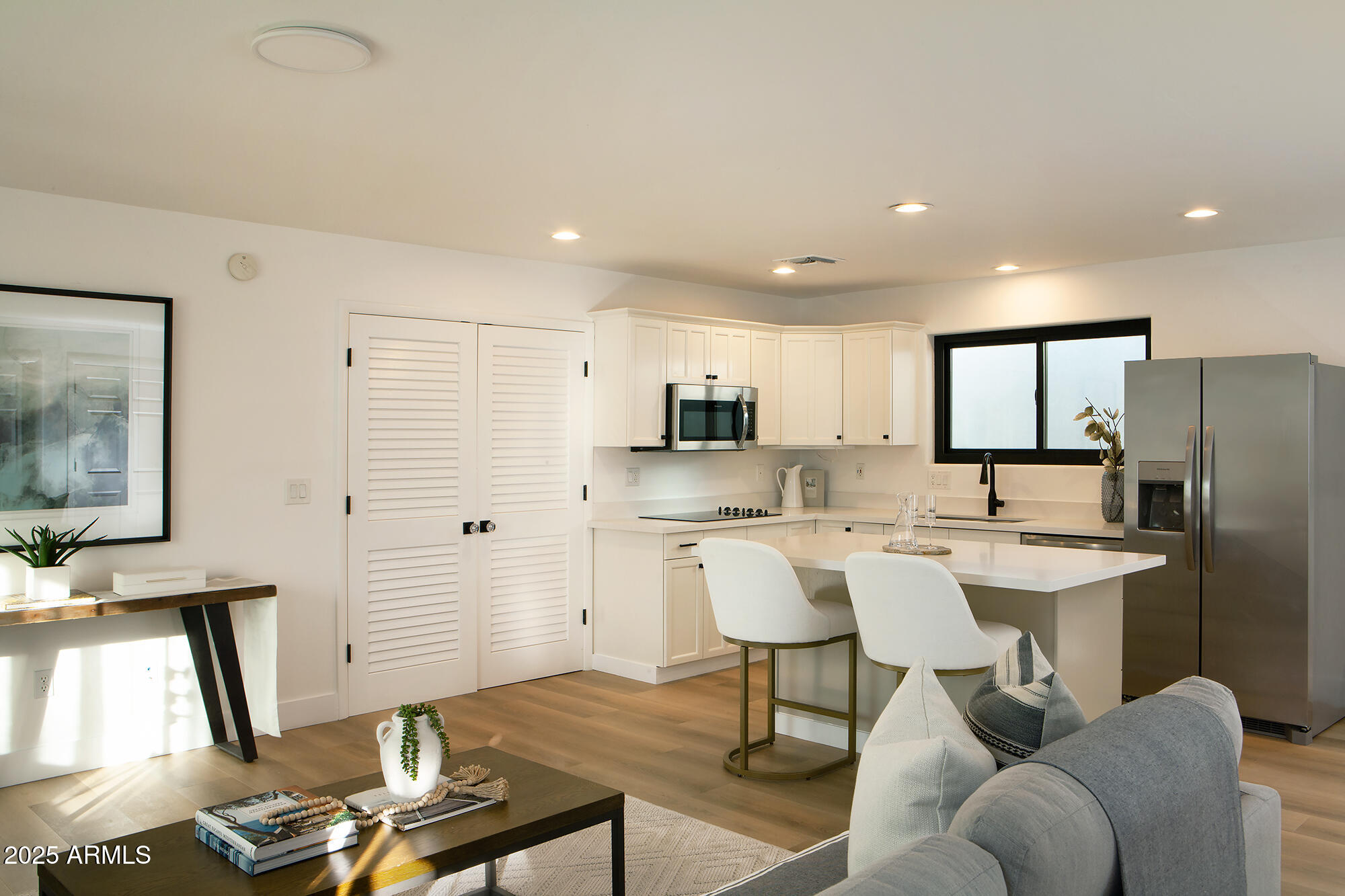 6302 East Cochise Road Paradise Valley, AZ 85253 - Photo 28 of 44 a living room with stainless steel appliances kitchen island granite countertop furniture and a large window