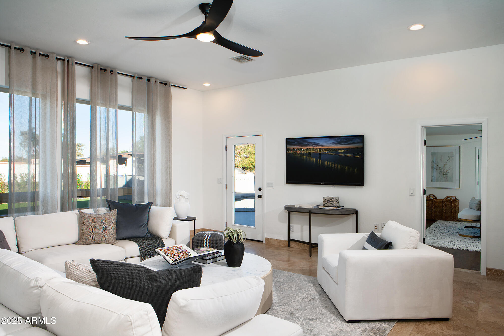6302 East Cochise Road Paradise Valley, AZ 85253 - Photo 3 of 44 a living room with furniture and a flat screen tv