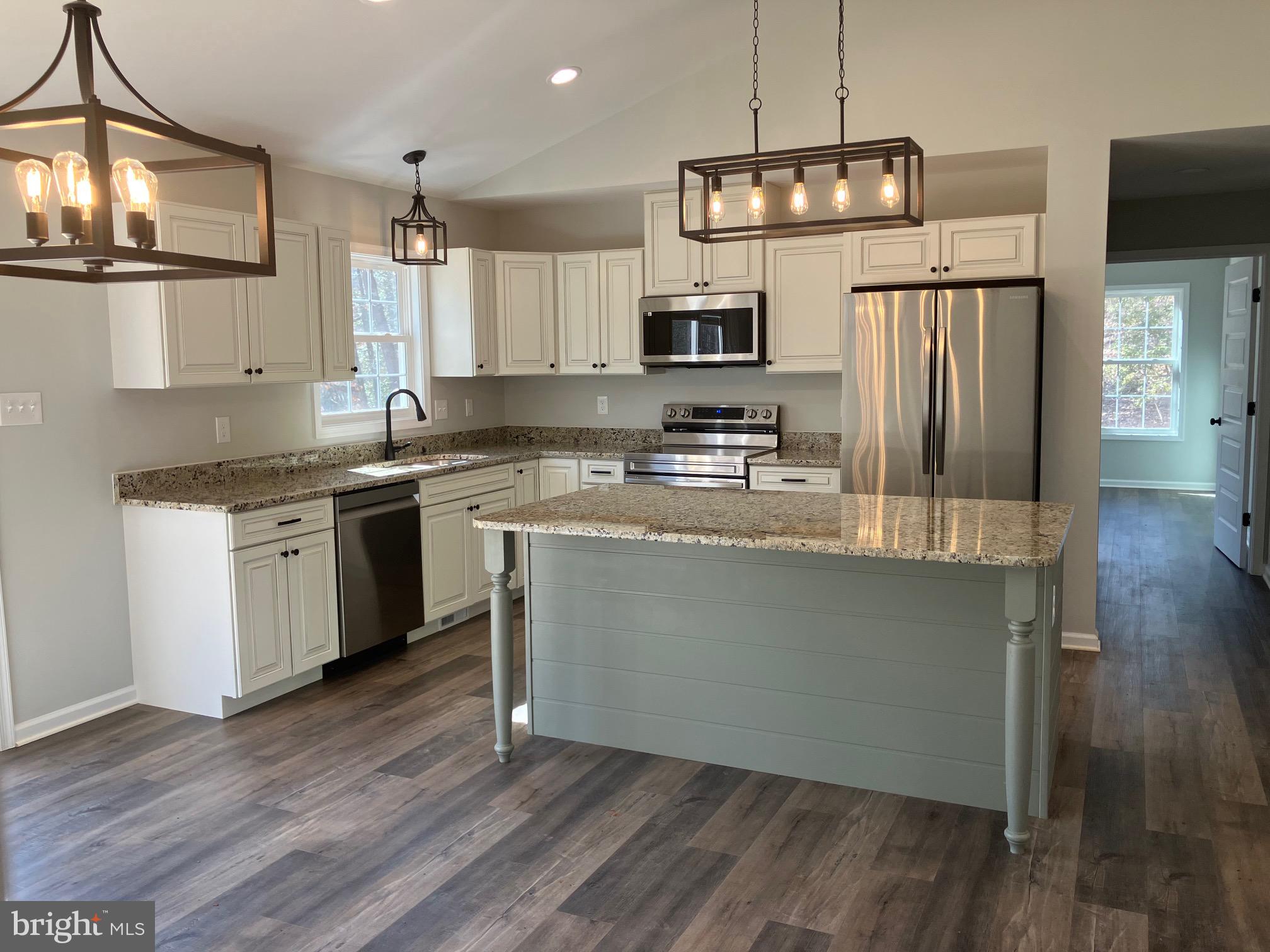 14400 Reva Road Reva, VA 22735 - Photo 2 of 9 a kitchen with stainless steel appliances granite countertop a sink a stove a refrigerator cabinets and a wooden floor