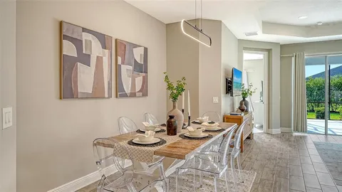 a dining room with furniture and wooden floor