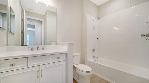 a bathroom with a sink a toilet and a bathtub