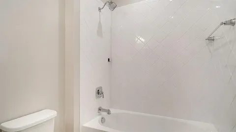 a bathroom with a bathtub and toilet