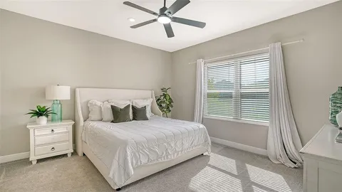 a bedroom with a large bed and a window