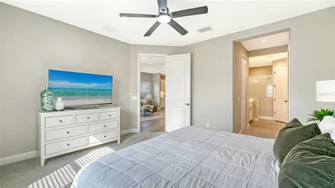 a bedroom with a bed and a television