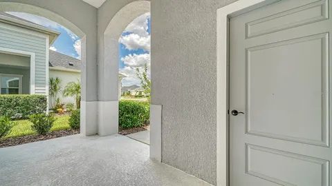 a view of a hallway with potted plants