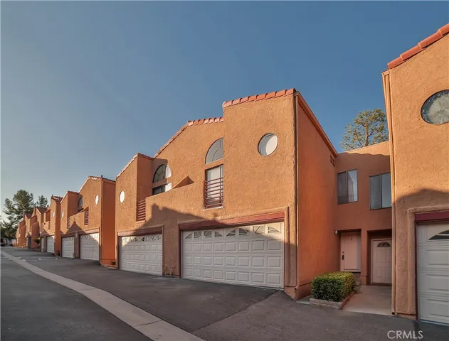 a view of a kitchen with a refrigerator and a stove top oven