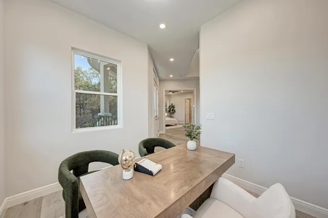 a white bath tub sitting next to a white sink and a toilet