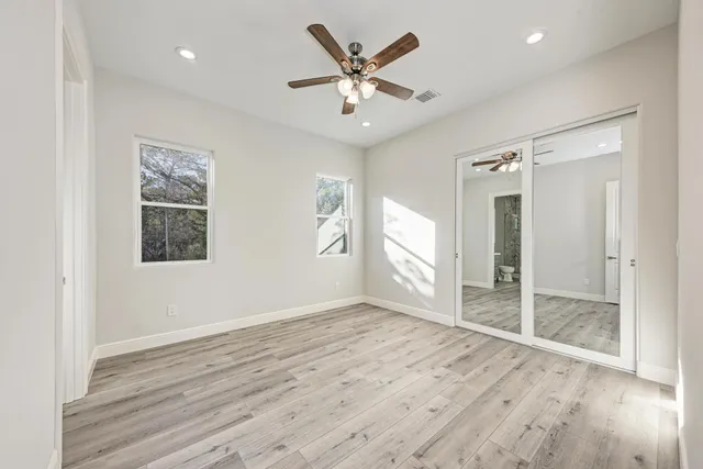 wooden floor in an empty room with a window