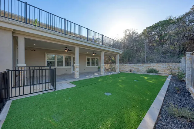 a view of a porch with furniture and a yard