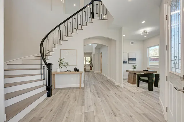 a view of entryway and hall with wooden floor