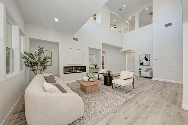 a living room with furniture and a chandelier