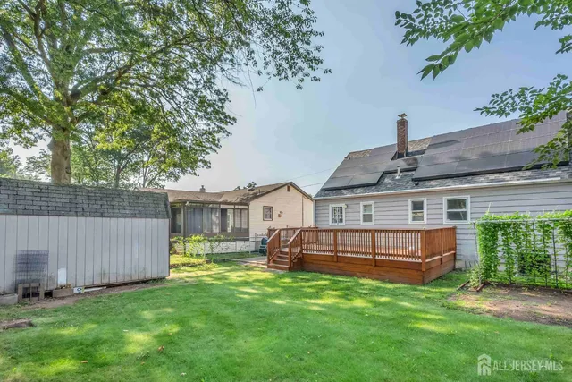 a view of a house with a yard and sitting area