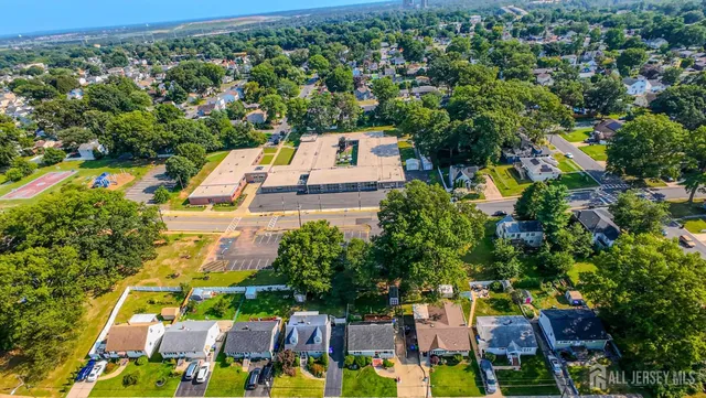 an aerial view of residential houses with outdoor space and street view