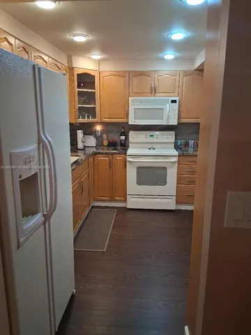 a kitchen with stainless steel appliances a refrigerator stove and microwave