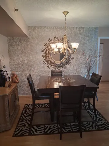 a dining room with furniture and a chandelier