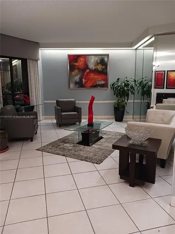 a living room with furniture a flat screen tv and a potted plant