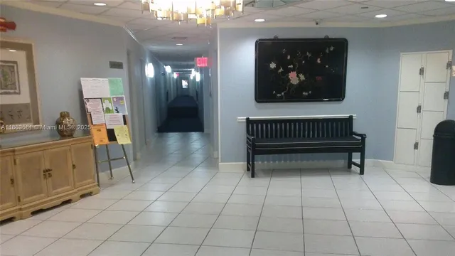 a room with lots of white furniture and a window